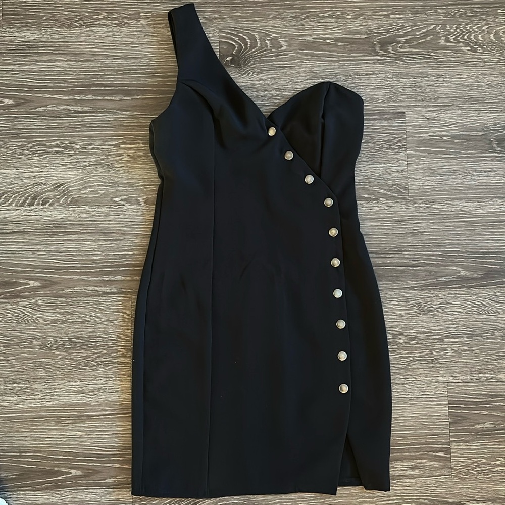 Black one shoulder strap dress with metallic buttons.
